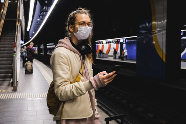 woman in beige coat wearing black headphones 3943952 1 Photo by Anna Shvets from Pexels